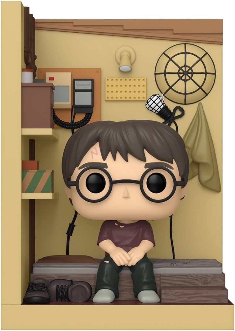 Funko Pop! vinyl figure of Harry Potter sitting in a miniature classroom scene, wearing his signature round glasses, purple shirt, and green pants.