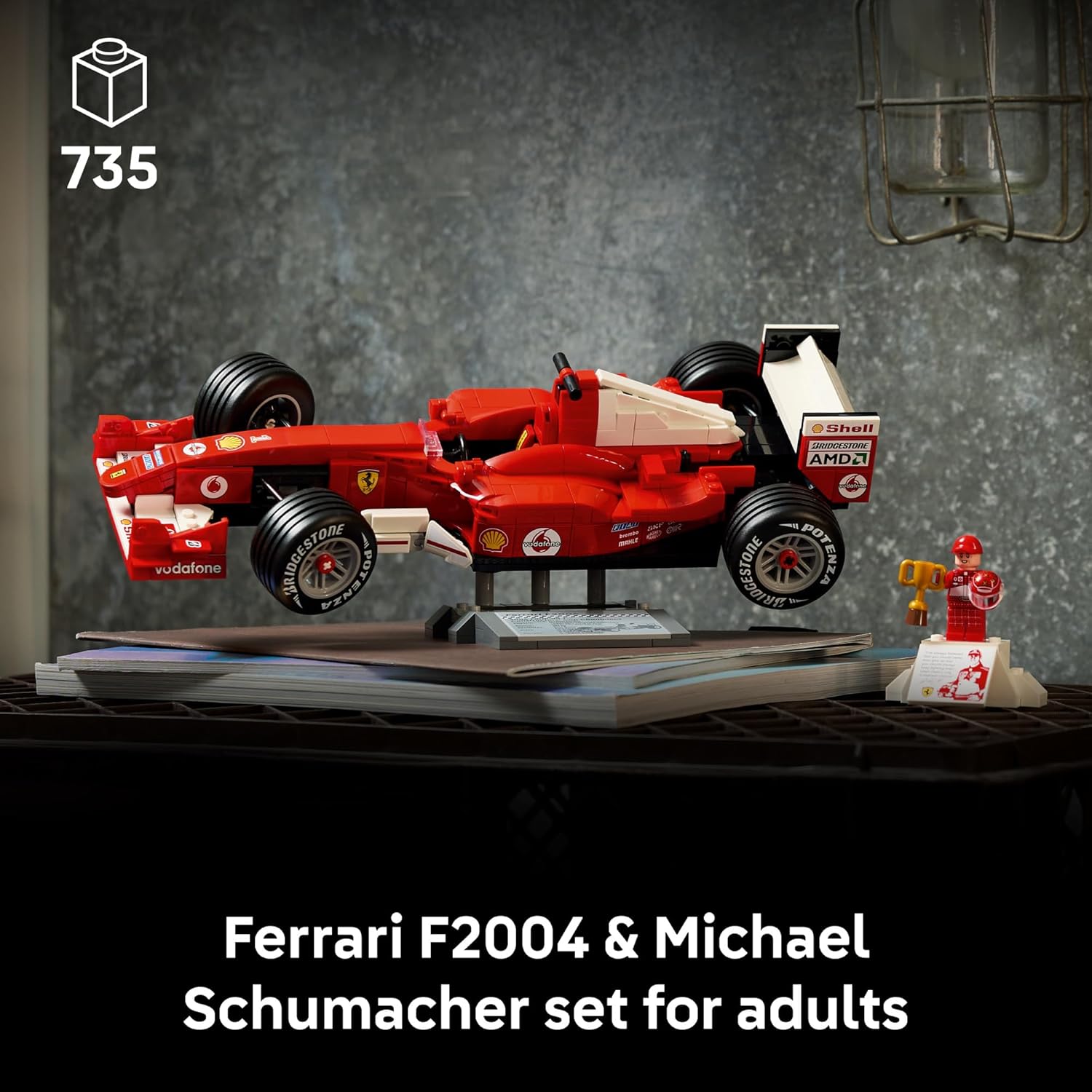 Model of a red Ferrari F2004 race car on a stand with a figure of Michael Schumacher
